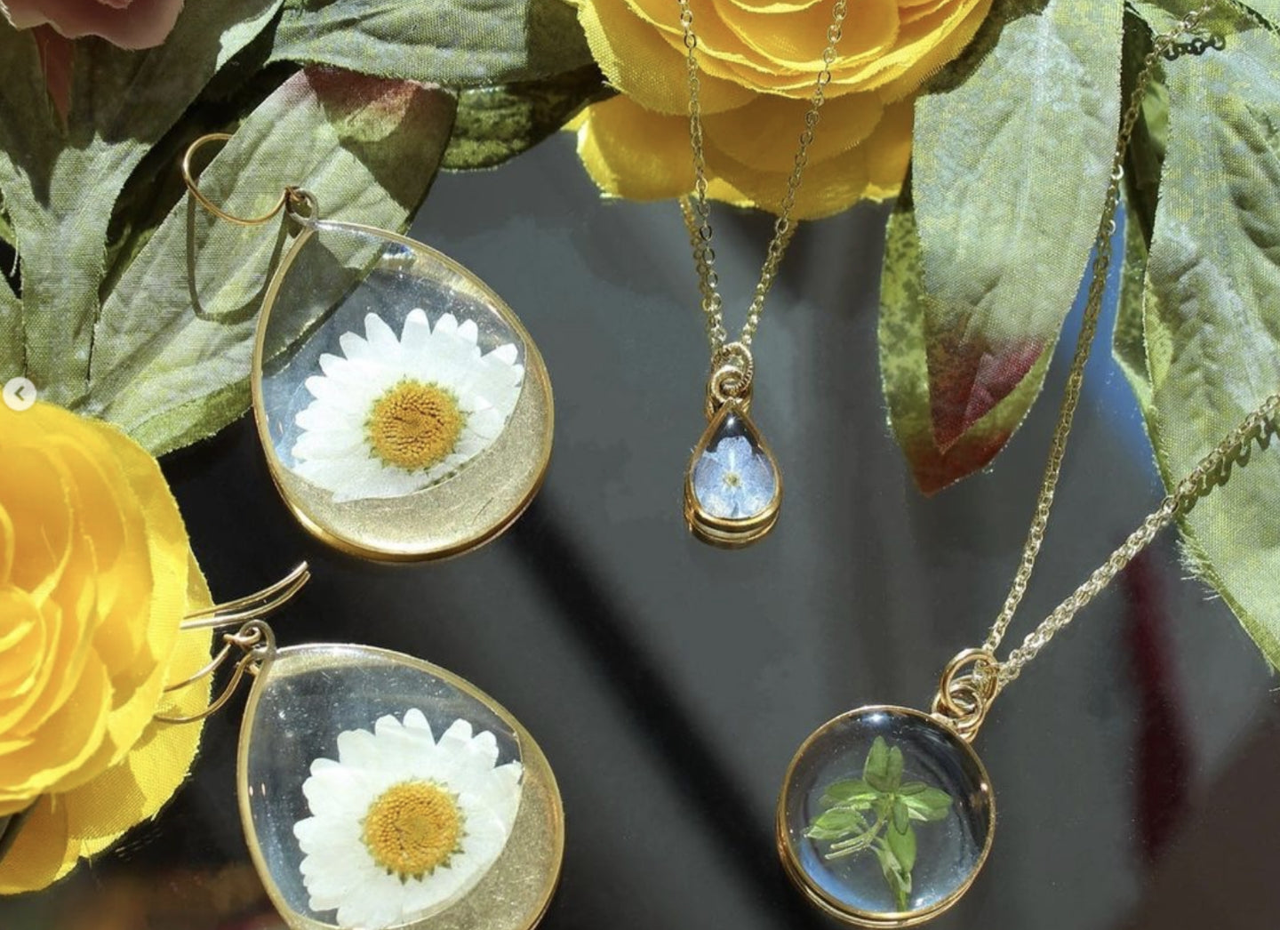 flower ensconced necklaces and earrings made by Seed & Soil