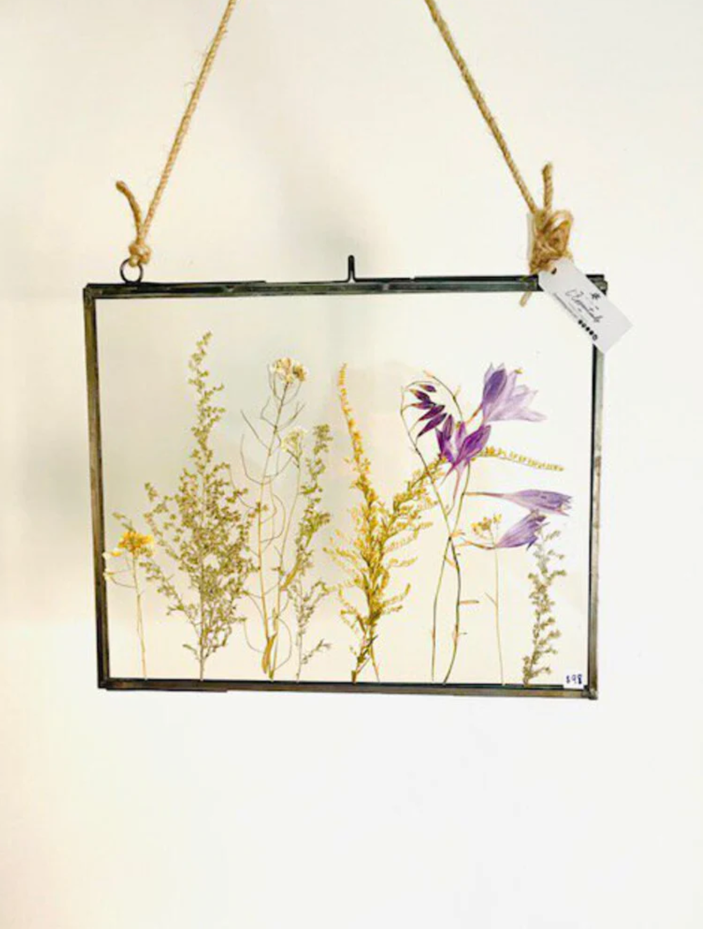 dried flowers encased in a glass frame made by l'essentials