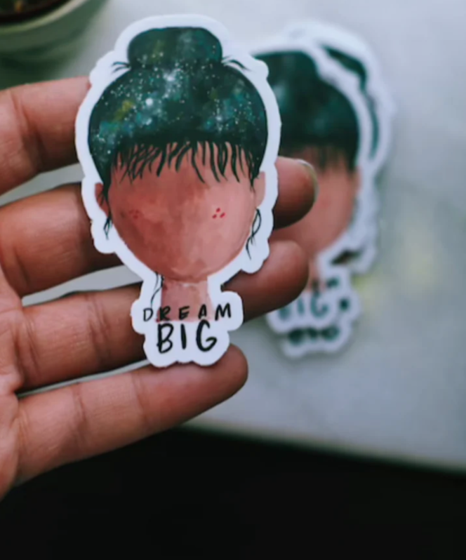 "dream big sticker" with  water color illustration of galaxy in girls mind, made by monellisa