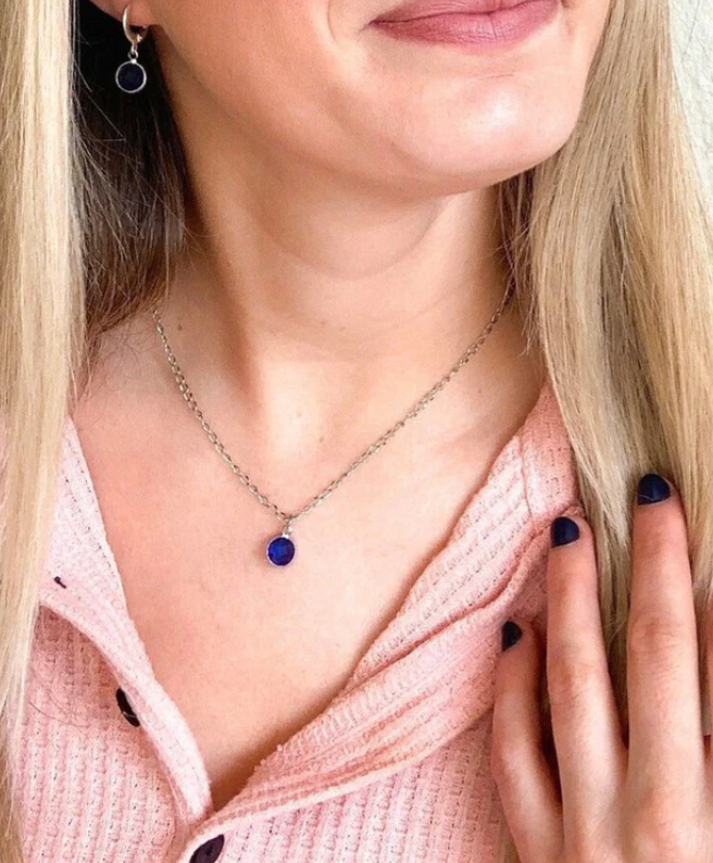 smiling woman wearing dark blue bead necklace from S.E.W. What Bead Company