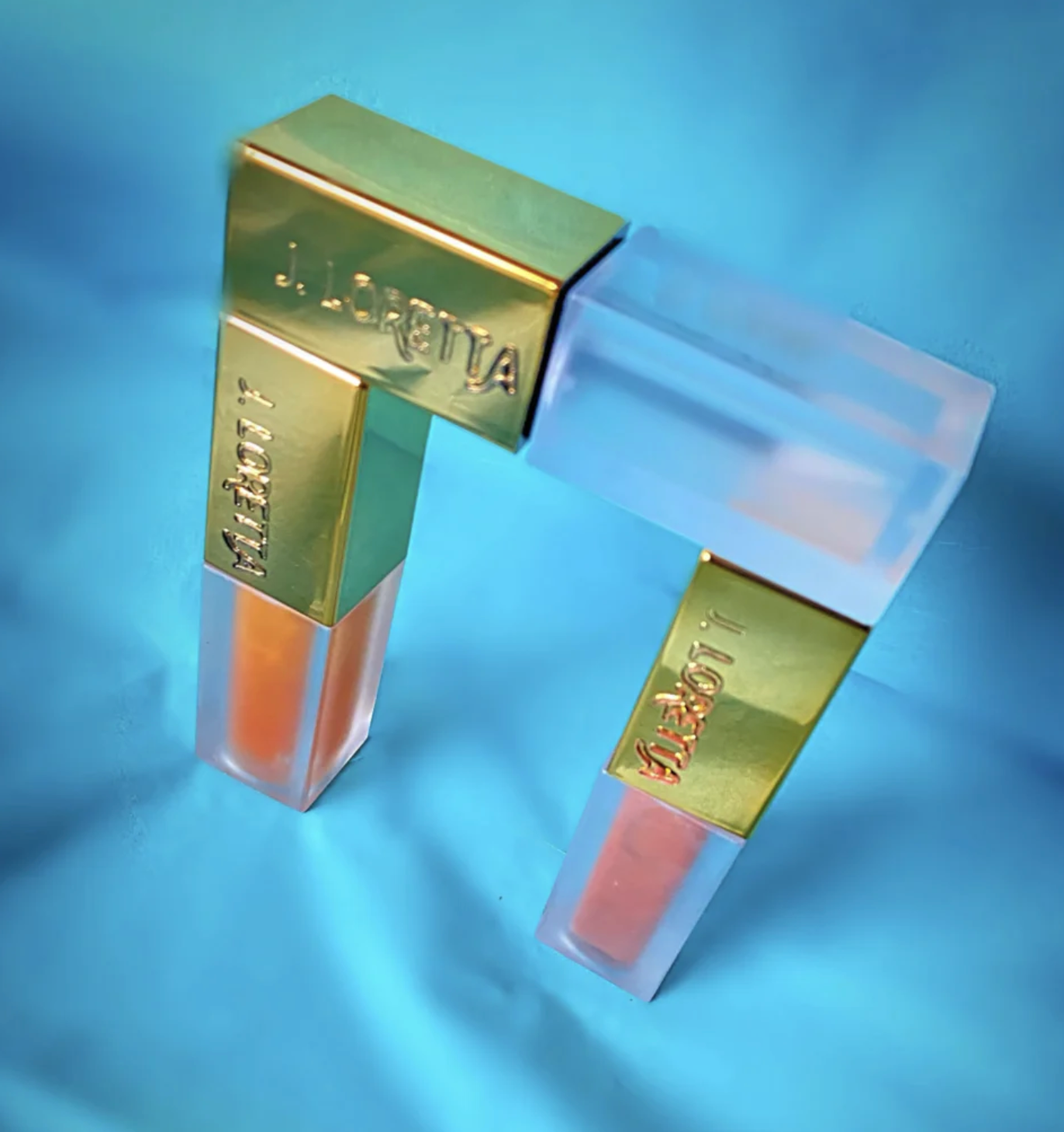 J Lorretta lip glosses stacked on each other