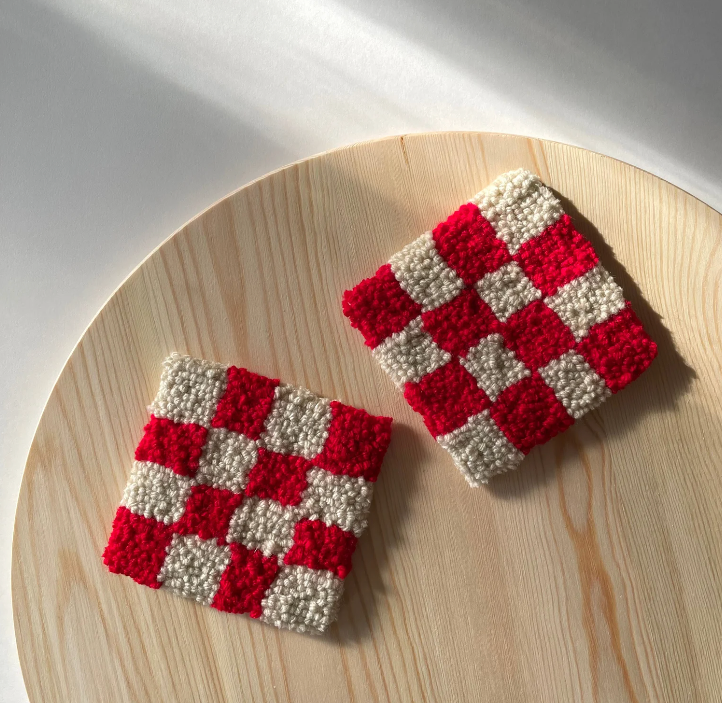 Checkerboard tufted coasters in red and cream, created by Annemade Studio