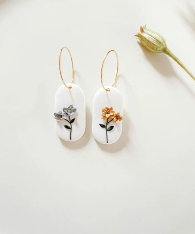 white dangly Earrings with delicate flowers created by the Dainty Flower Shop