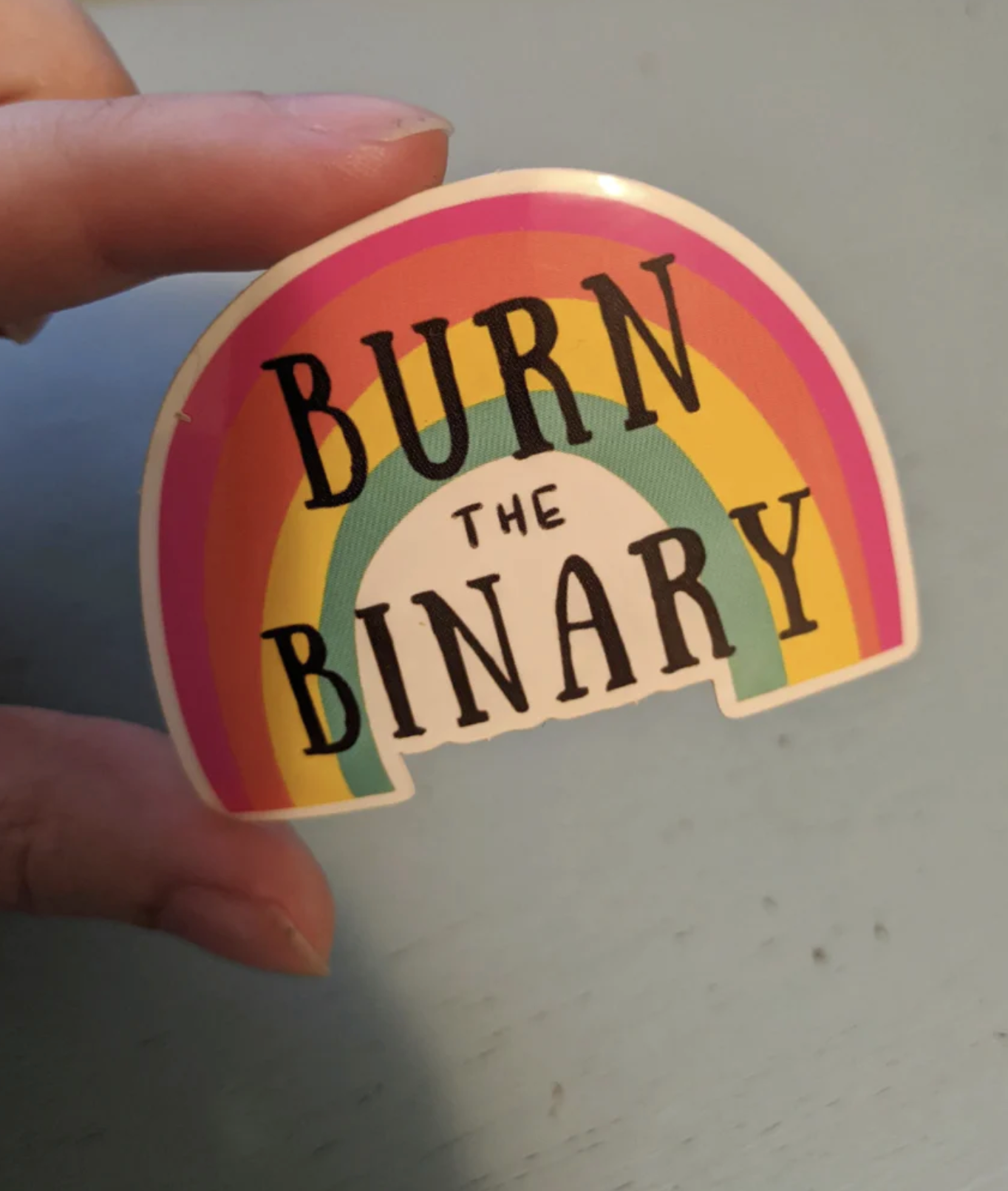 "burn the binary" sticker with a rainbow, made by Heart & Hustle Handmade